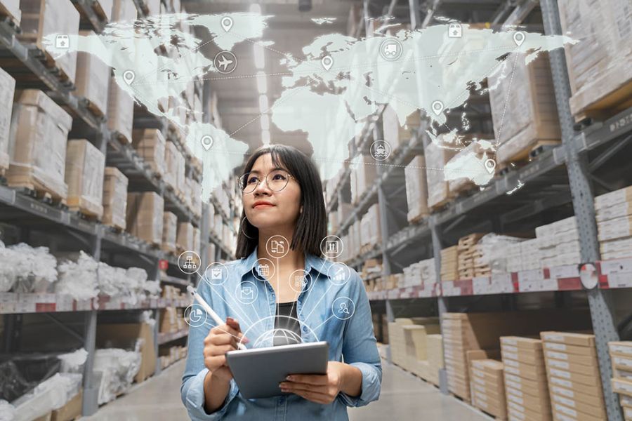 Woman walking through a factory with a clipboard and checklist, representing the quality management services provided in Chinese factories by Western High Woman walking through a factory with a clipboard and checklist, representing the quality management services provided in Chinese factories by Western High